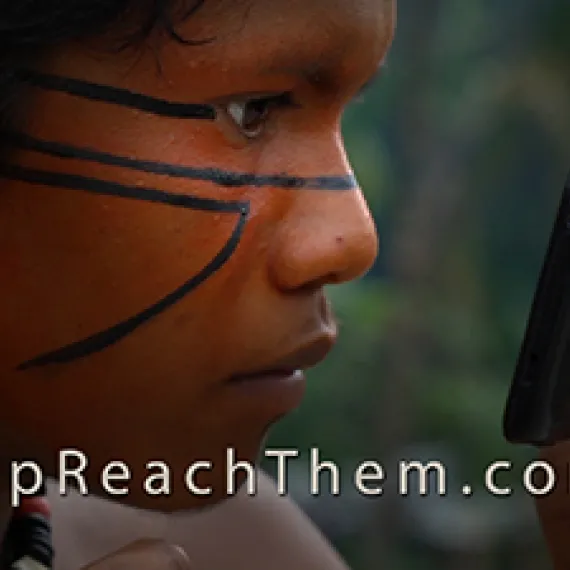 Person with face paint drawing lines while looking into a smartphone.